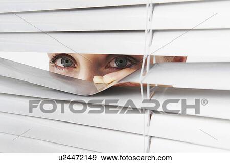 Woman looks through blinds View Large Photo Image Stock Photo - Woman looks through blinds. Fotosearch