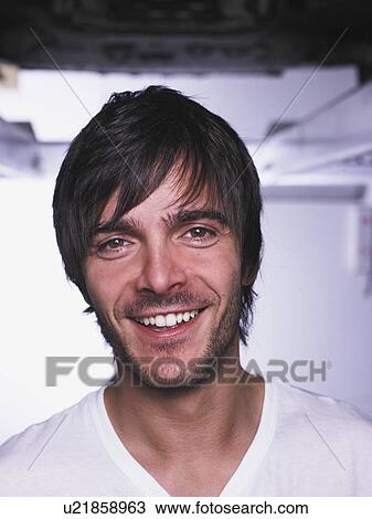 Stock Image - Garage worker standing in shop. Fotosearch