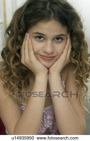 Girl (9-11) leaning with hands on chin, portrait View Large Photo Image Stock Image - Girl (9-11) leaning with hands on chin, portrait. Fotosearch