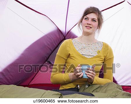 Girl sitting in sleeping bag in pink tent with mug View Large Photo Image Stock Photography - Girl sitting in sleeping bag in pink tent with mug. Fotosearch
