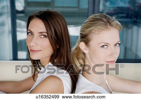 Portrait of two women on a sofa. View Large Photo Image Stock Photo - Portrait of two women on a sofa.. Fotosearch