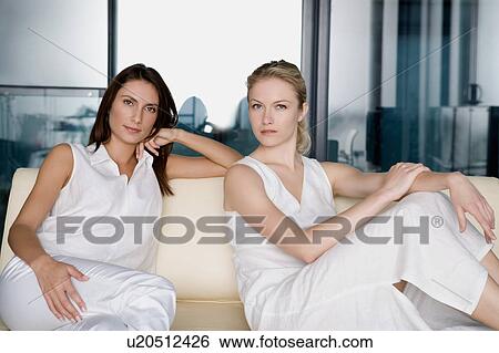 Portrait of two women on a sofa. View Large Photo Image Stock Photograph - Portrait of two women on a sofa.. Fotosearch