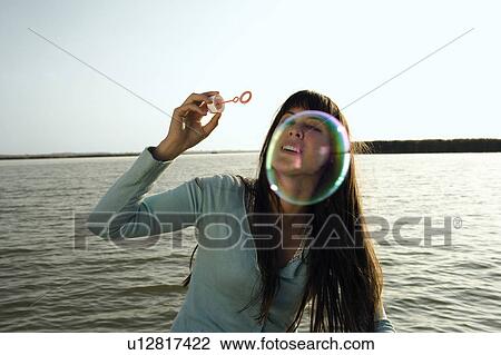 Woman blowing bubble. View Large Photo Image Stock Image - Woman blowing bubble.. Fotosearch