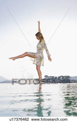 Young woman by poolside. View Large Photo Image Stock Image - Young woman by poolside.. Fotosearch