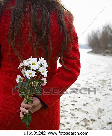 Young woman holding flowers behind back, rear, mid-section View Large Photo Image Stock Image - Young woman holding flowers behind back, rear, mid-section. Fotosearch