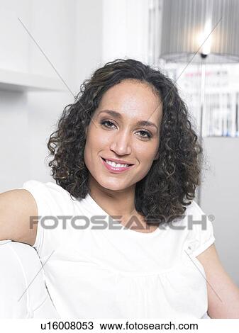 Young woman smiling, portrait View Large Photo Image Stock Image - Young woman smiling, portrait. Fotosearch