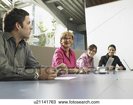 Businesspeople in a meeting View Large Photo Image Stock Image - Businesspeople in a meeting. Fotosearch