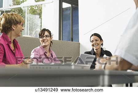 Businesspeople in a meeting View Large Photo Image Stock Photo - Businesspeople in a meeting. Fotosearch