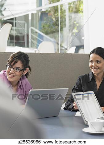 Businesspeople in a meeting View Large Photo Image Stock Photograph - Businesspeople in a meeting. Fotosearch