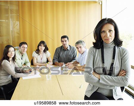 Businesswoman in meeting room, portrait, colleagues in background View Large Photo Image Stock Photo - Businesswoman in meeting room, portrait, colleagues in background. Fotosearch