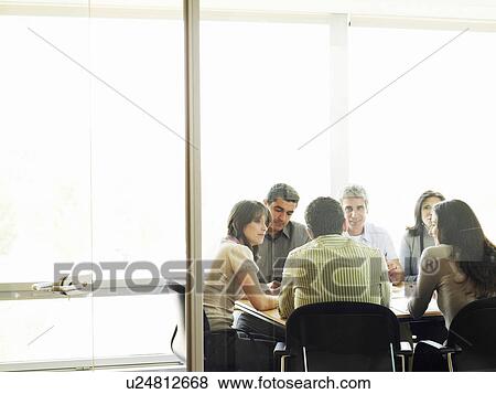 Colleagues in meeting, view through doorway View Large Photo Image Stock Photo - Colleagues in meeting, view through doorway. Fotosearch
