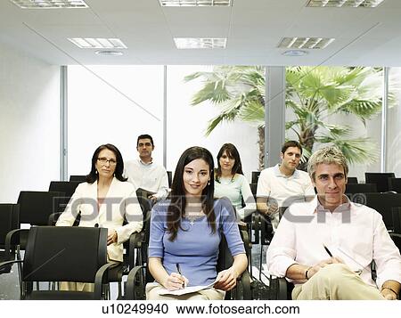 Colleagues watching presentation, portrait View Large Photo Image Stock Image - Colleagues watching presentation, portrait. Fotosearch