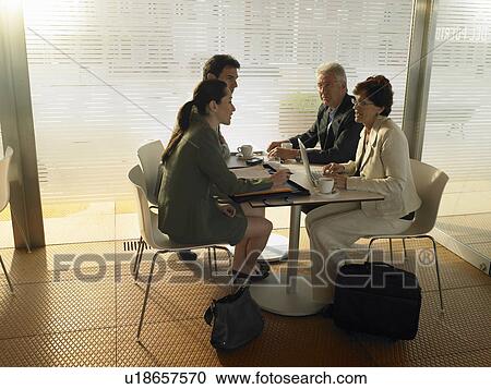 Two businessmen and two businesswomen having meeting in café, afternoon. Alicante, Spain. View Large Photo Image Stock Image - Two businessmen and two businesswomen having meeting in café, afternoon. Alicante, Spain.. Fotosearch