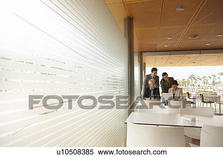 Two businessmen and two businesswomen having meeting in café, Alicante, Spain. View Large Photo Image Stock Photography - Two businessmen and two businesswomen having meeting in café, Alicante, Spain.. Fotosearch