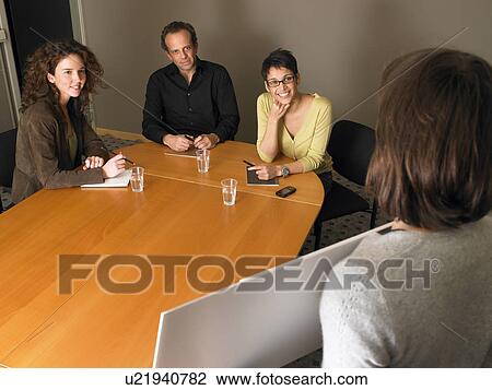 Stock Image - Woman giving presentation in business meeting. Brussels, Belgium.. Fotosearch