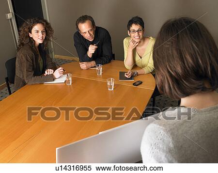 Woman giving presentation to colleagues in meeting room View Large Photo Image Stock Photography - Woman giving presentation to colleagues in meeting room. Fotosearch