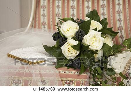 bridal bouquet, veil and purse on chair, close-up View Large Photo Image Stock Photo - bridal bouquet, veil and purse on chair, close-up. Fotosearch