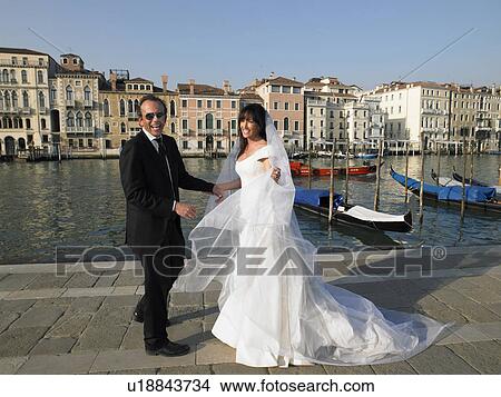 Bride and groom laughing. Grand Canal, Venice, Italy. View Large Photo Image Picture - Bride and groom laughing. Grand Canal, Venice, Italy.. Fotosearch