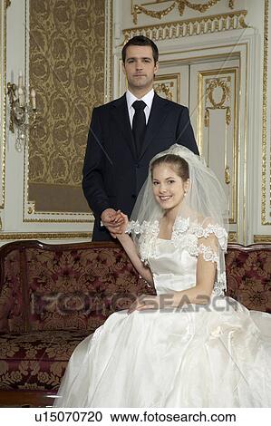 Stock Image - Bride and groom smiling, portrait. Fotosearch