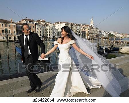 Picture - Bride and groom walking. Grand Canal, Venice, Italy.. Fotosearch