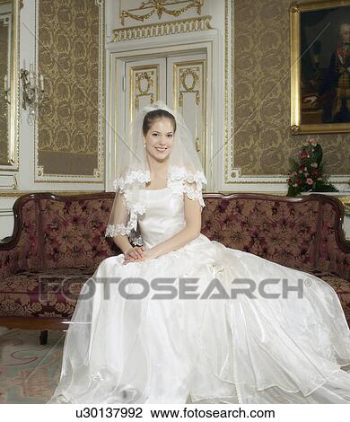 Stock Image - Bride in wedding dress, smiling, portrait. Fotosearch