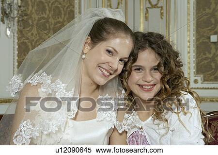 Girl (9-11) standing with bride, smiling, portrait View Large Photo Image Stock Photography - Girl (9-11) standing with bride, smiling, portrait. Fotosearch
