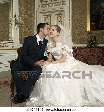 Groom kissing the bride, smiling View Large Photo Image Stock Photo - Groom kissing the bride, smiling. Fotosearch
