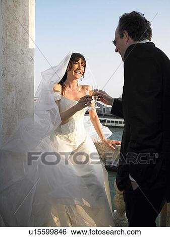 Italy, Venice, bride and groom toasting with champagne, smiling View Large Photo Image Stock Photograph - Italy, Venice, bride and groom toasting with champagne, smiling. Fotosearch