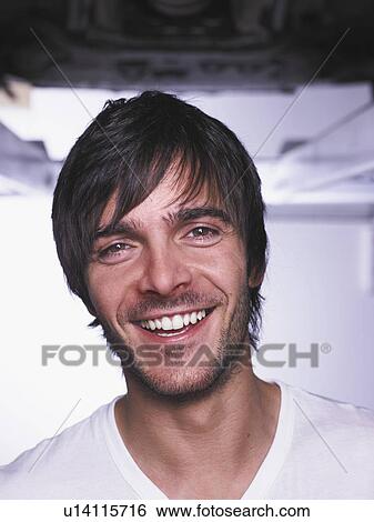 Stock Photograph - Garage worker standing in shop. Fotosearch