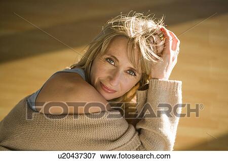 Mature woman relaxing in a gym View Large Photo Image Stock Photo - Mature woman relaxing in a gym. Fotosearch