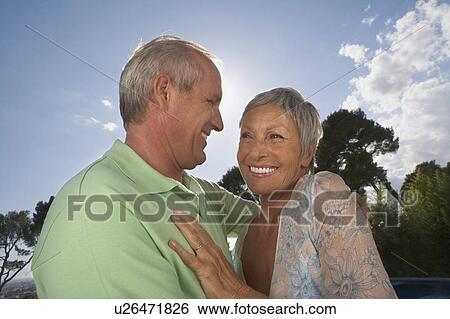 Older couple hugging on terrace. View Large Photo Image Stock Photograph - Older couple hugging on terrace.. Fotosearch