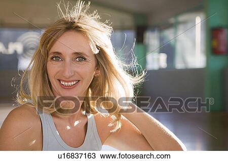 Stock Image - Portrait of a mature woman in a gym. Fotosearch