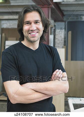 Stock Photo - Portrait of carpenter in his workshop.. Fotosearch