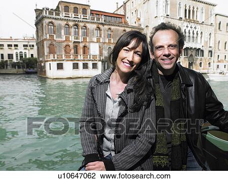 Portrait of man and woman in boat on canal. Venice. View Large Photo Image Stock Image - Portrait of man and woman in boat on canal. Venice.. Fotosearch