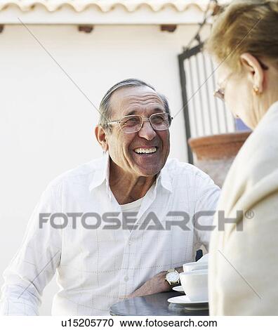 Senior couple having drinks in garden, smiling View Large Photo Image Stock Image - Senior couple having drinks in garden, smiling. Fotosearch