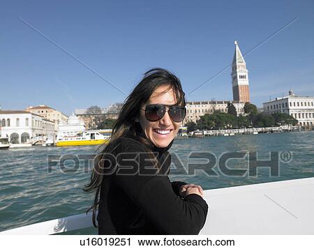 Woman on a boat near St Mark's Square looking at camera. Venice, Italy. View Large Photo Image Stock Image - Woman on a boat near St Mark's Square looking at camera. Venice, Italy.. Fotosearch