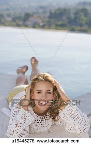 Woman relaxing by a pool. View Large Photo Image Stock Photo - Woman relaxing by a pool.. Fotosearch