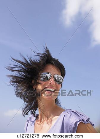 Woman smiling, blue sky View Large Photo Image Stock Photo - Woman smiling, blue sky. Fotosearch