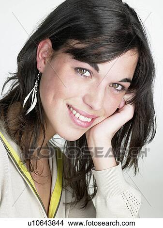 Picture - Woman smiling resting head on hand.. Fotosearch