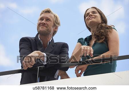 Young businessman and business woman on balcony. View Large Photo Image Stock Photo - Young businessman and business woman on balcony.. Fotosearch