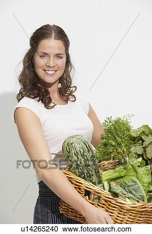 Young woman with large basket of organic vegetables. View Large Photo Image Stock Image - Young woman with large basket of organic vegetables.. Fotosearch