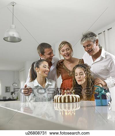 Family sitting around a birthday cake View Large Photo Image Stock Image - Family sitting around a birthday cake. Fotosearch