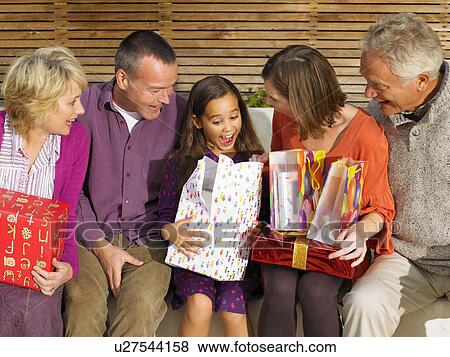 Girl (8-10) opening presents View Large Photo Image Stock Photo - Girl (8-10) opening presents. Fotosearch