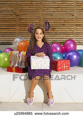 Girl (8-10) with birthday presents View Large Photo Image Stock Photography - Girl (8-10) with birthday presents . Fotosearch