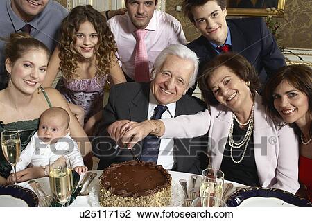 Grandparents with multigenerational family cutting cake View Large Photo Image Stock Image - Grandparents with multigenerational family cutting cake. Fotosearch