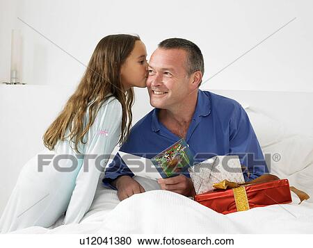Man looking at card with daughter View Large Photo Image Stock Image - Man looking at card with daughter. Fotosearch