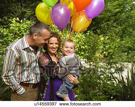 Mother, father and baby with balloons View Large Photo Image Stock Photo - Mother, father and baby with balloons. Fotosearch