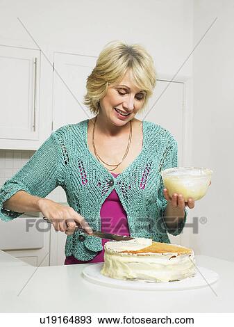 Senior woman decorating cake View Large Photo Image Stock Image - Senior woman decorating cake. Fotosearch