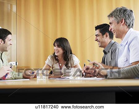 Businessmen and businesswoman in meeting, smiling View Large Photo Image Stock Image - Businessmen and businesswoman in meeting, smiling. Fotosearch