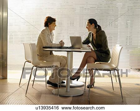 Stock Photograph - Businesswomen in a restaurant.. Fotosearch
